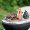  Ceramic farmer with buffalo figurine by a rock. This Buffalo statue Outdoor is durable.