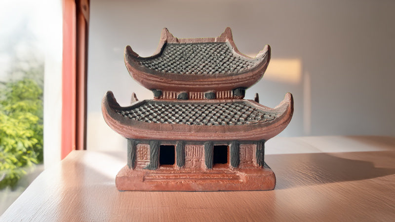 Close-up of Northern pagoda ceramic statue, focusing on tile roof details, patterns, and warm colors