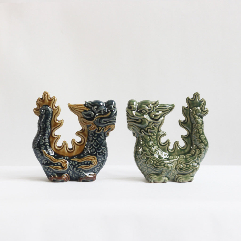 Two protective dragon statue home decor figurines, one blue and one green, are shown side-by-side.