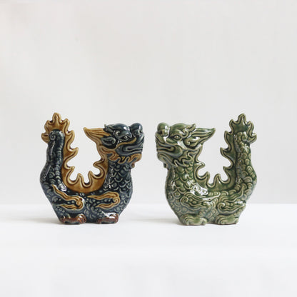 Two protective dragon statue home decor figurines, one blue and one green, are shown side-by-side.