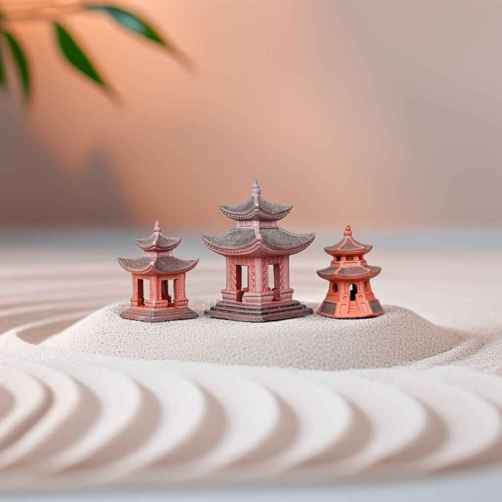 Three small Japanese pagoda statues, bonsai figurines for Zen garden decor.