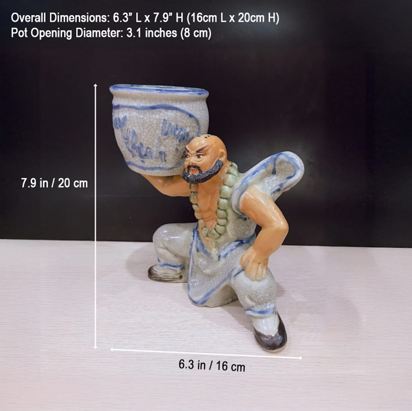  A ceramic mudman, a figurine bonsai planter, with height and width dimensions shown.