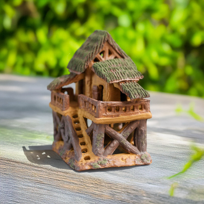 This whimsical miniature treehouse, handmade from natural clay, perches playfully on stilts, adding a touch of enchantment to any aquarium or terrarium.