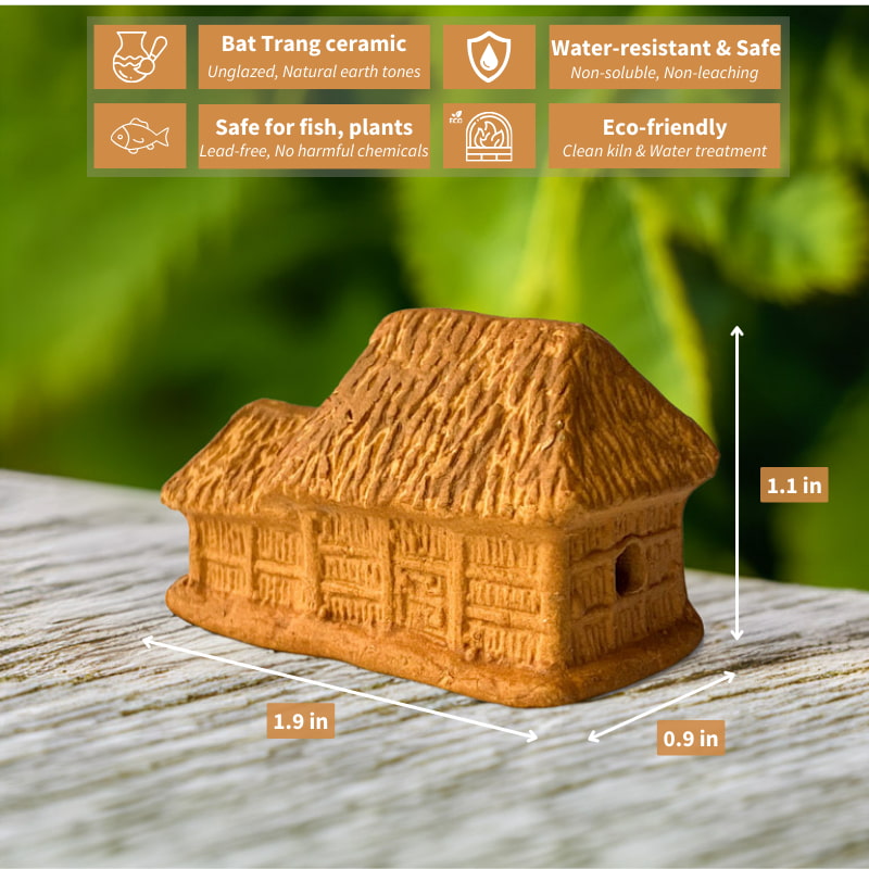 This miniature Vietnamese house, with its distinctive thatched roof and rustic terracotta finish, sits charmingly on a weathered wooden surface, adding a touch of cultural heritage to any space.