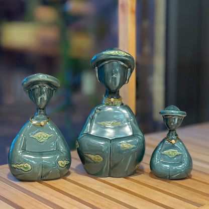Three duck-green Vietnamese ceramic woman figurines in small, medium and large sizes