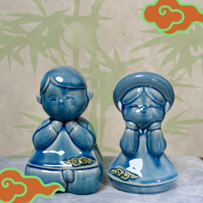 Blue-glazed Vietnamese boy and girl figurines with bamboo background and cloud graphics