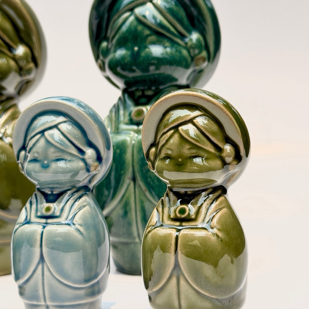 Dark green Vietnamese ceramic couple figurines styled with bamboo and paper fans