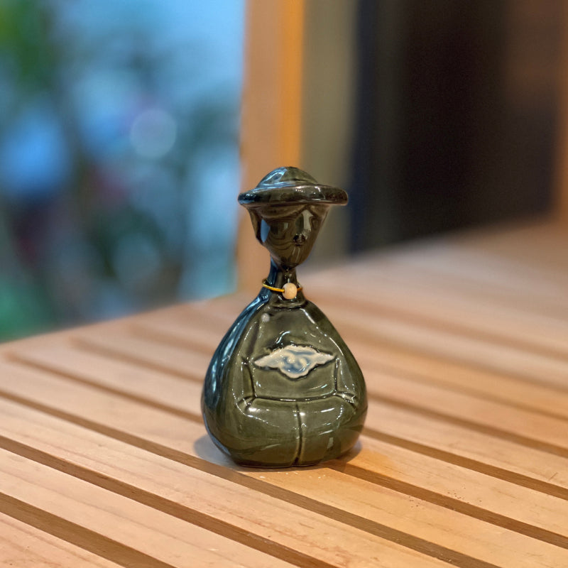 Front view of a small duck-green Vietnamese woman ceramic figurine