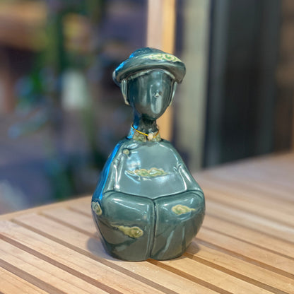 Close-up of a duck-green Vietnamese traditional woman ceramic figurine