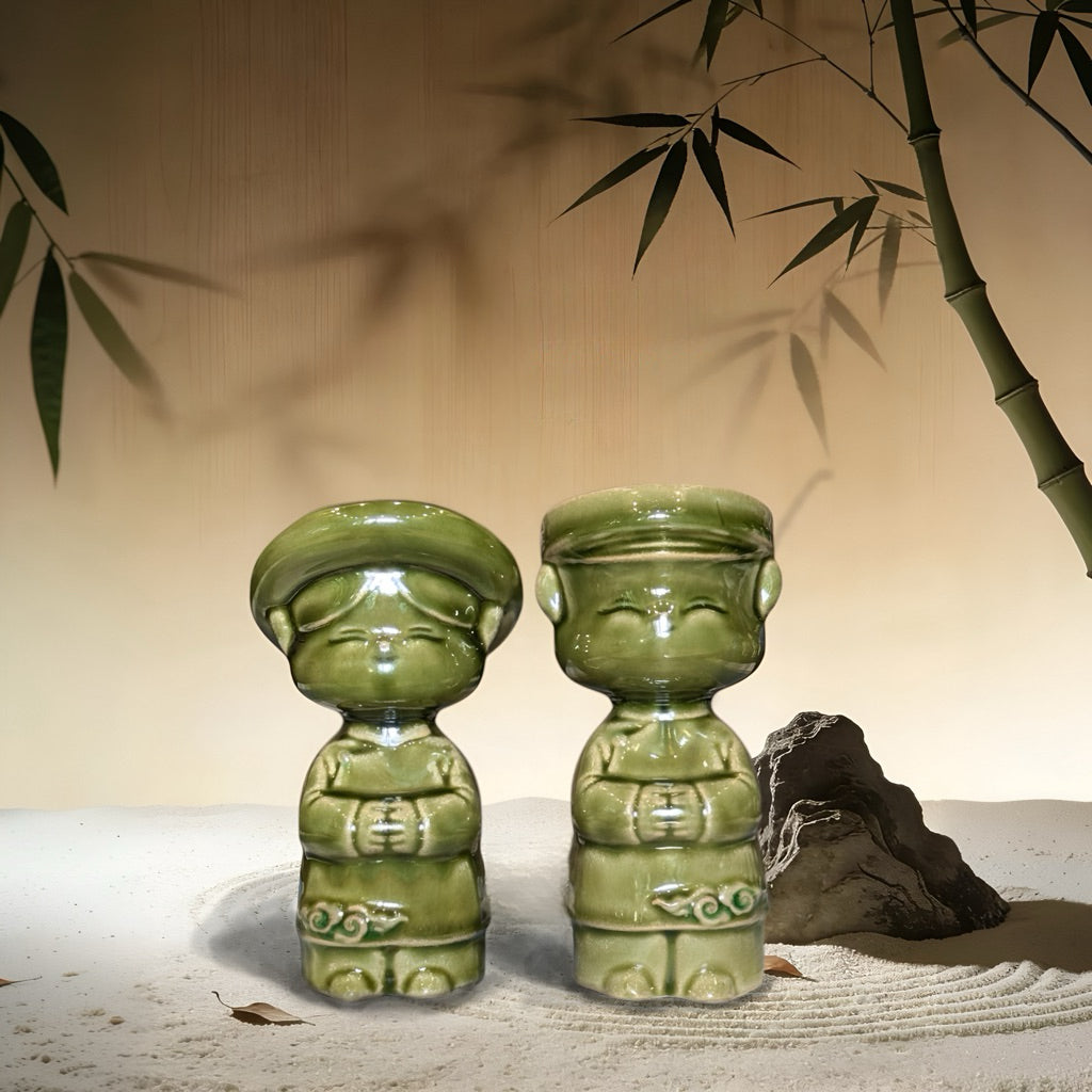 Green-glazed Vietnamese ao dai children couple figurines in a zen garden setting