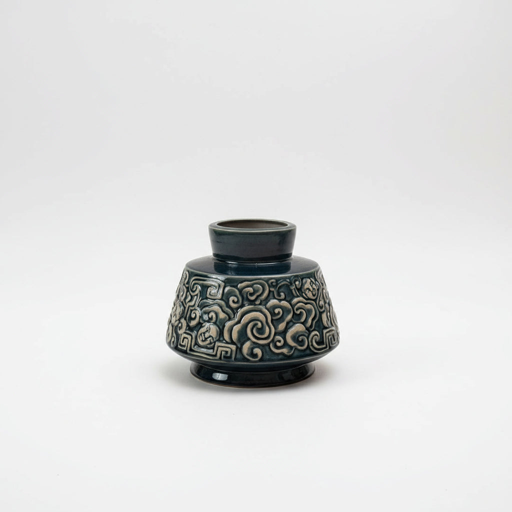A deep blue Vietnamese ceramic vase with a unique cloud motif. This stunning ash glaze vase.