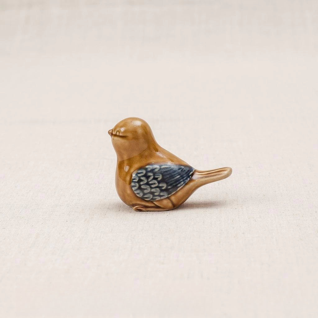 Close-up of a yellow-glazed Vietnamese ceramic bird figurine