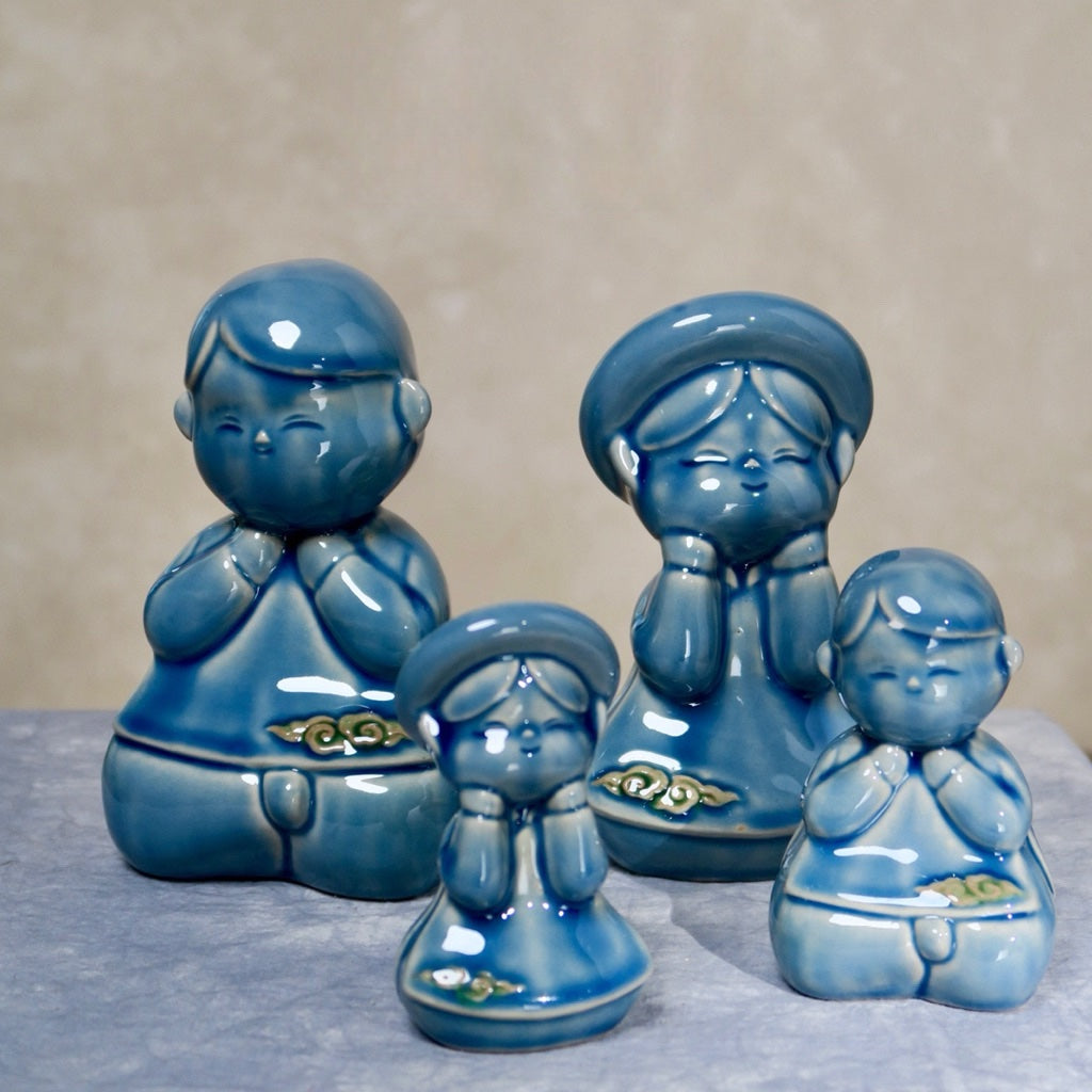 Group of blue-glazed seated Vietnamese children figurines, boy and girl pairs