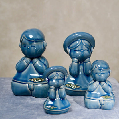 Group of blue-glazed seated Vietnamese children figurines, boy and girl pairs